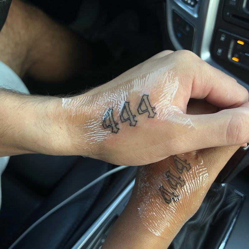 Two Hands with 444 Tattoos